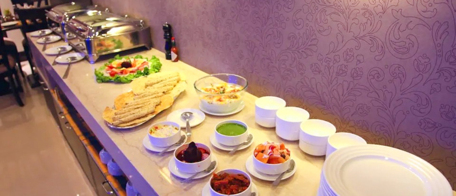 A vibrant buffet spread with Indian dishes, salads, and flatbreads at a welcome dinner in New Delhi.