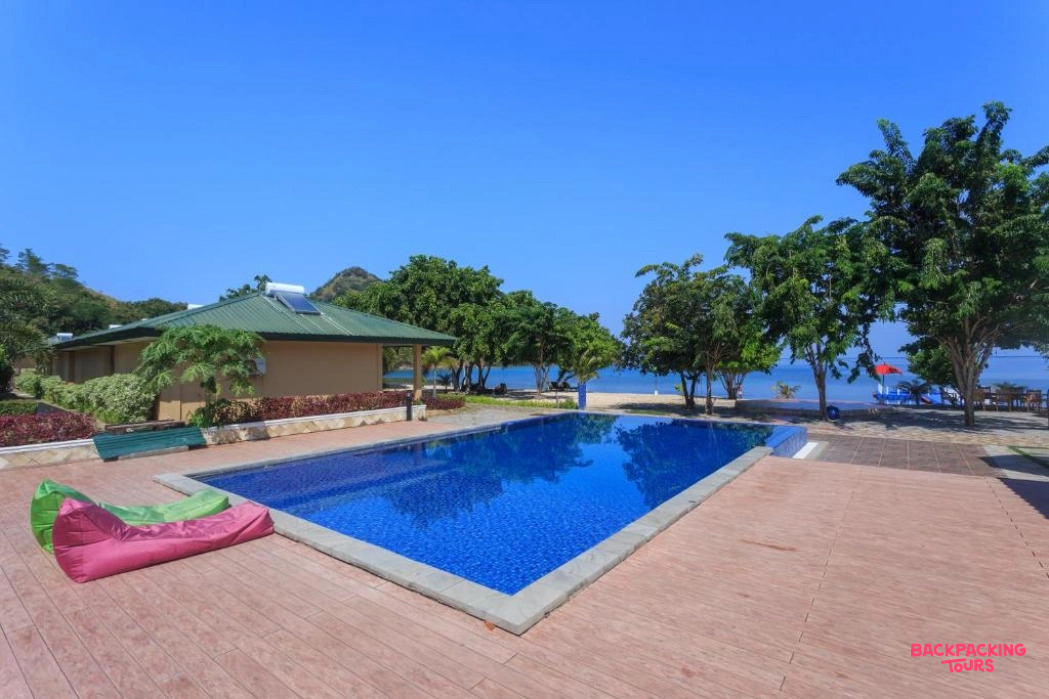 Relax by the sparkling pool at your Labuan Bajo resort, steps from the sandy beach.