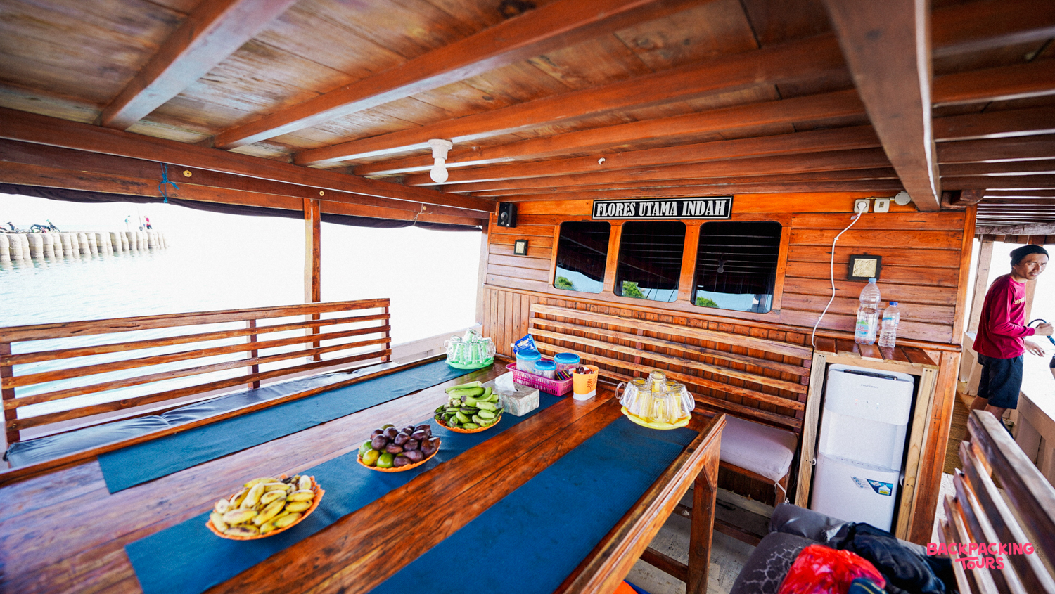 Fresh fruit and snacks laid out on a traditional wooden live-aboard boat near Satonda Island.