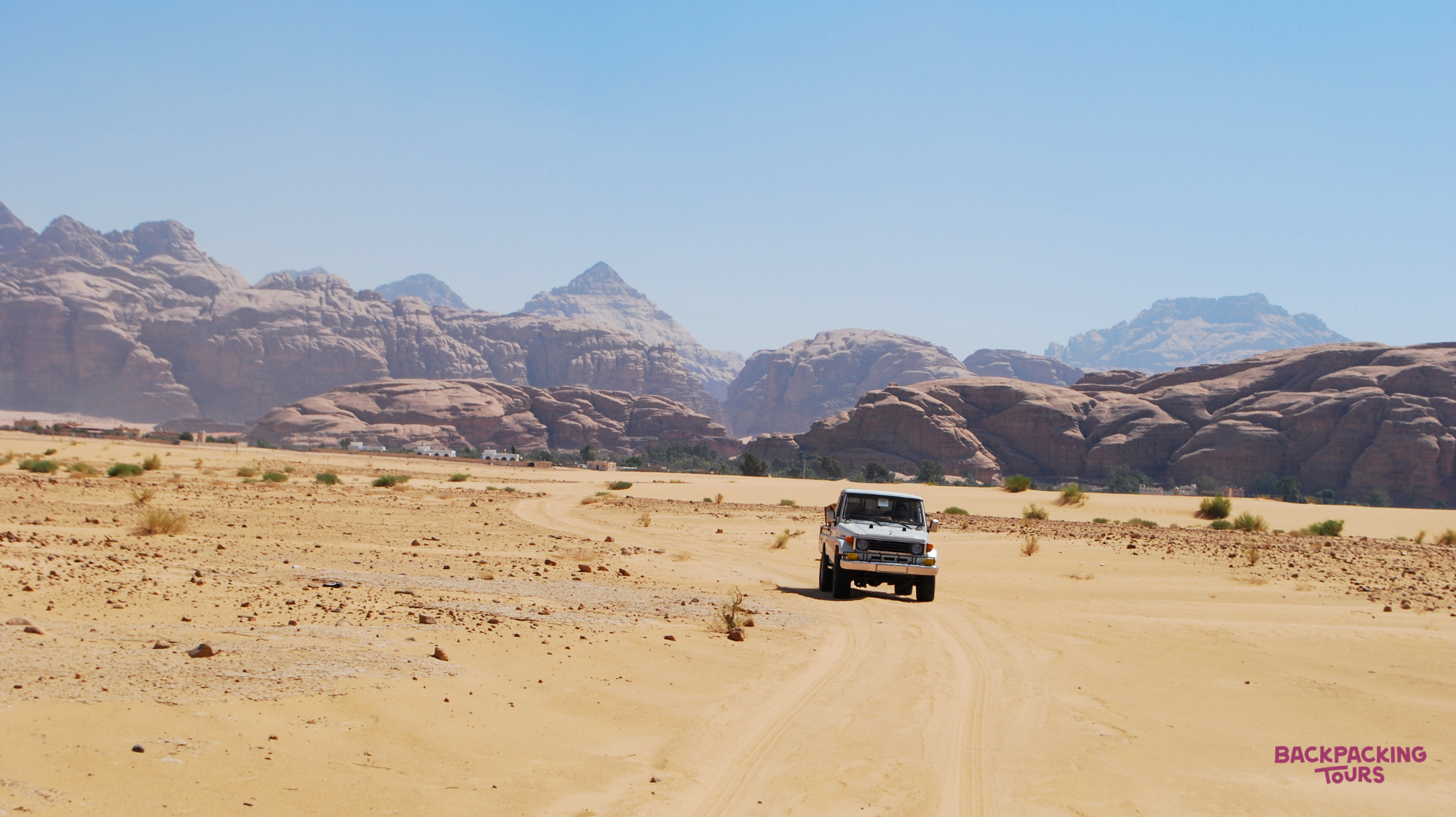A thrilling jeep safari through the expansive, sandy desert of Wadi Rum, surrounded by majestic mountains.