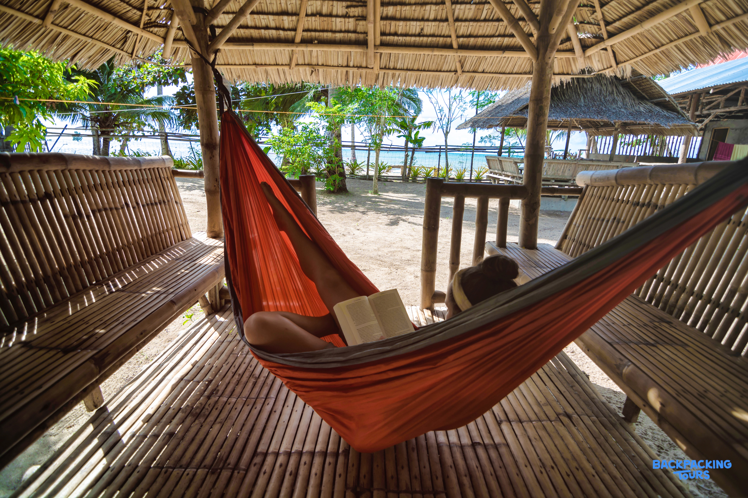 Enjoying a book in a comfortable hammock at a beachside accommodation in the Philippines.