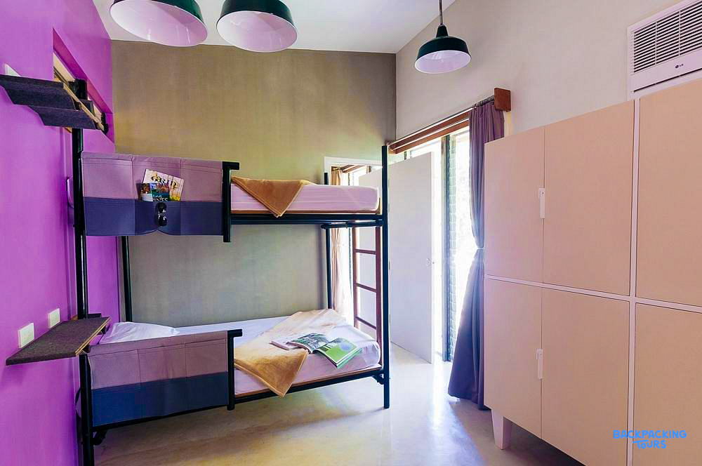 A modern and clean hostel room in El Nido, with comfortable bunk beds and personal lockers.