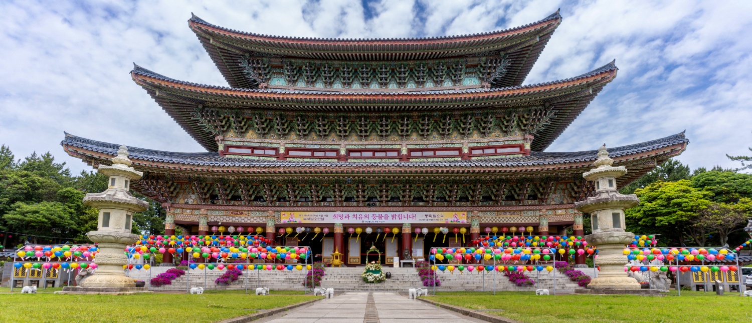 The magnificent Yakcheonsa Temple on Jeju Island, South Korea, decorated with numerous colorful lanterns.