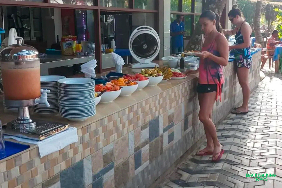 Guests enjoy a fresh fruit buffet breakfast at their tropical accommodation in Mirissa, Sri Lanka.