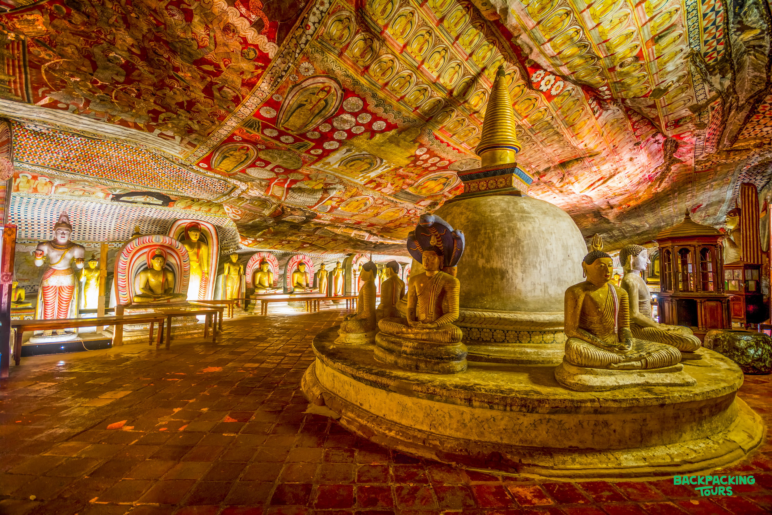 Exploring the Dambulla Cave Temple, featuring a large stupa, many Buddha statues, and vibrant ceiling murals.
