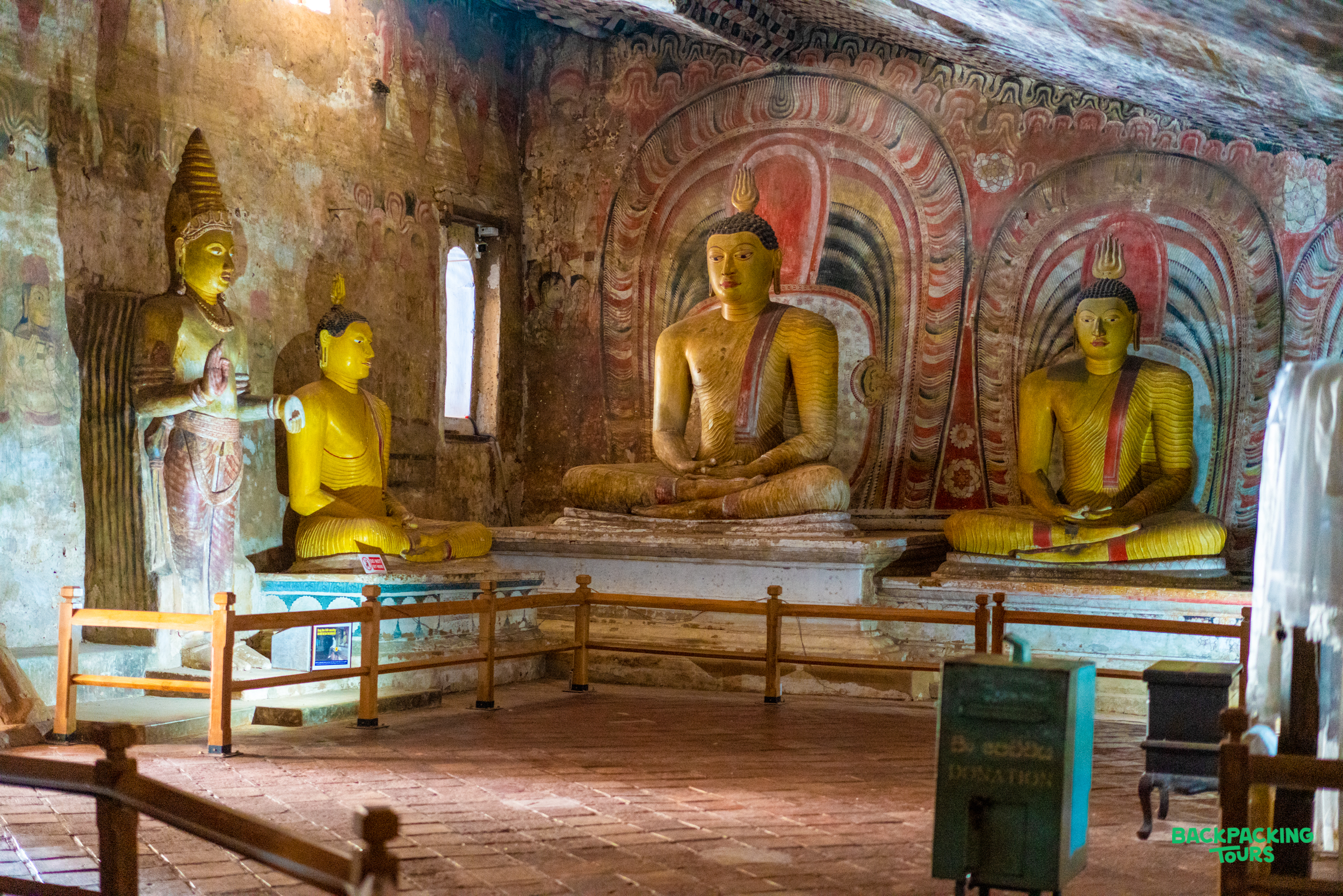 Golden Buddha statues and ancient murals inside the sacred Dambulla Cave Temple in Sri Lanka.