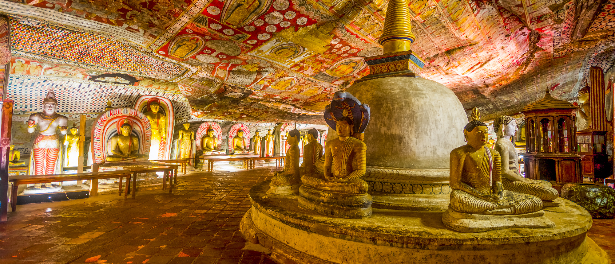 The ancient Dambulla Cave Temple in Sri Lanka, filled with many Buddha statues and vibrant frescoes.