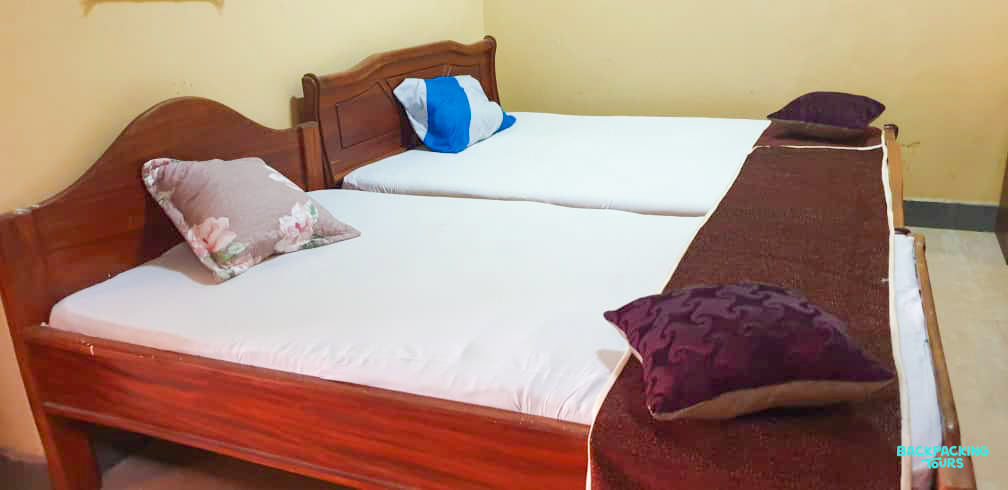 A bright and clean room with two single beds, offering comfortable accommodation in Zanzibar.