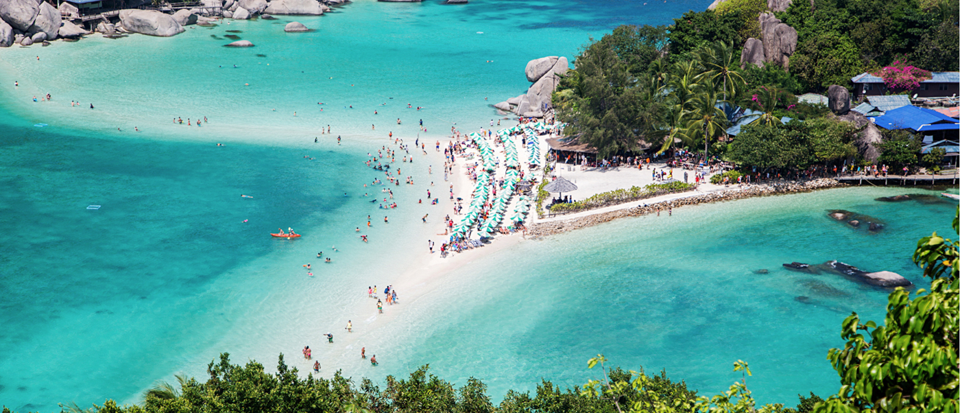 Beautiful Koh Nangyuan island from above, showing clear turquoise water, white sandbars, and many people.