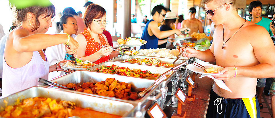 Tourists enjoy a delicious buffet meal at a casual outdoor restaurant on Koh Tao.