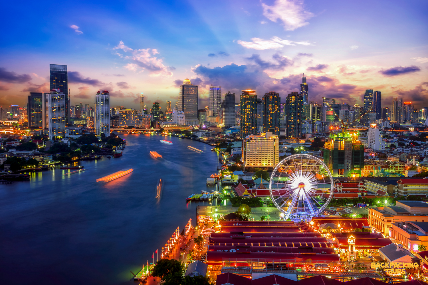 The vibrant Bangkok skyline at twilight, showcasing illuminated skyscrapers, a river, and a Ferris wheel.
