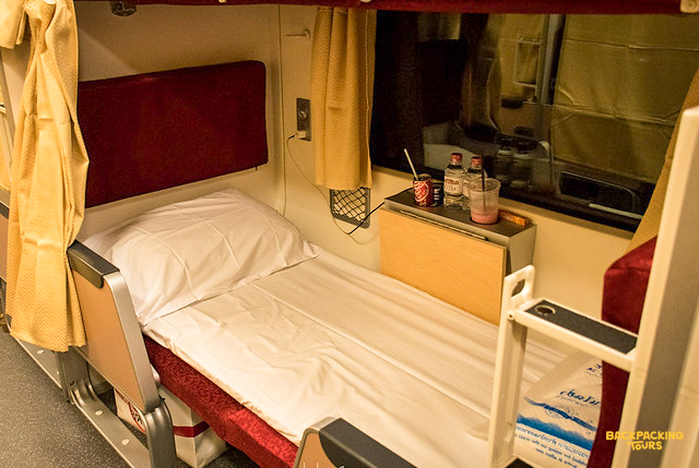 Relax in your private sleeping berth on the overnight train through Thailand's scenic countryside.