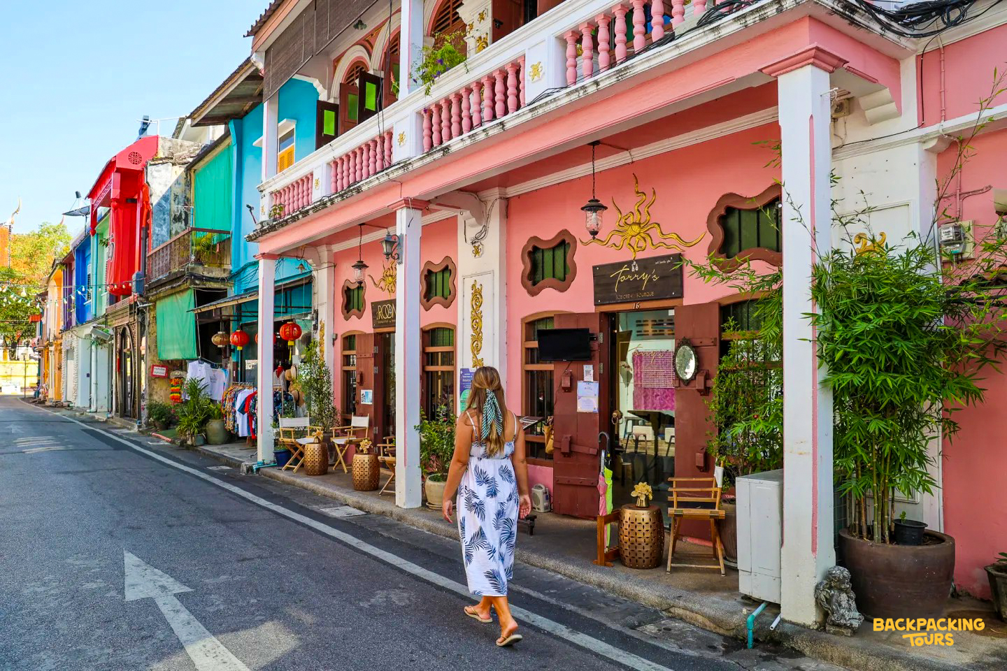 Woman exploring the vibrant streets and colorful Sino-Portuguese architecture of Phuket Old Town.