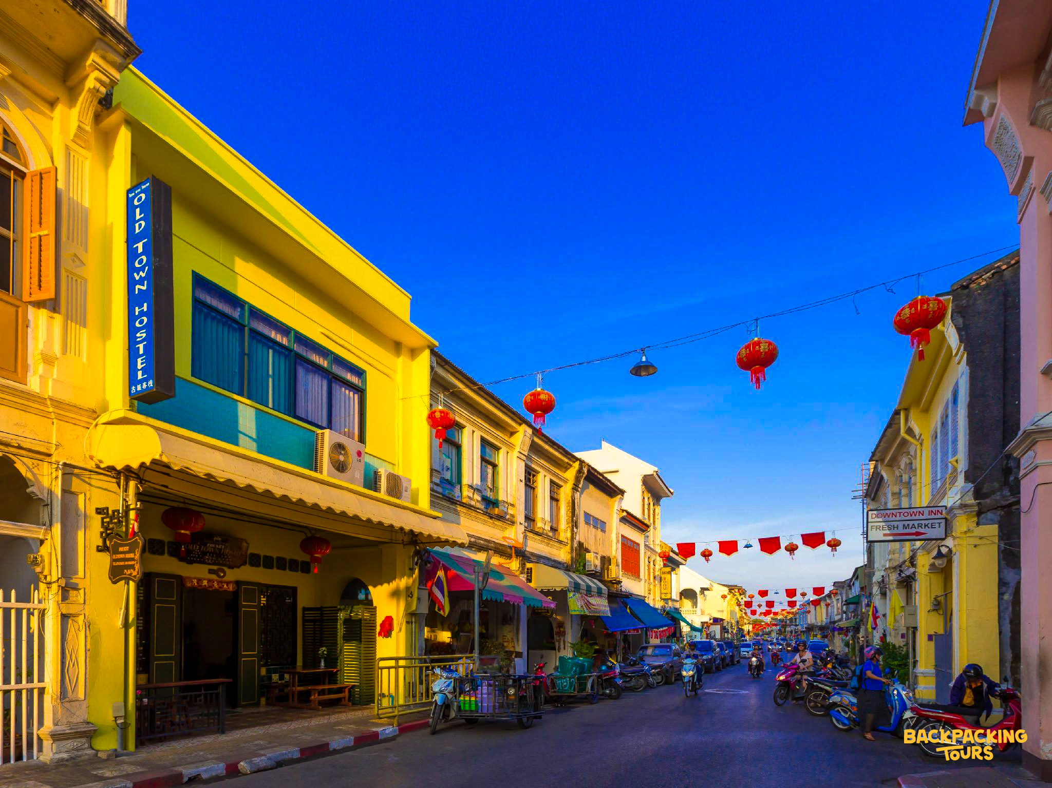 Colorful Sino-Portuguese buildings and red lanterns create a lively atmosphere in Phuket Old Town.