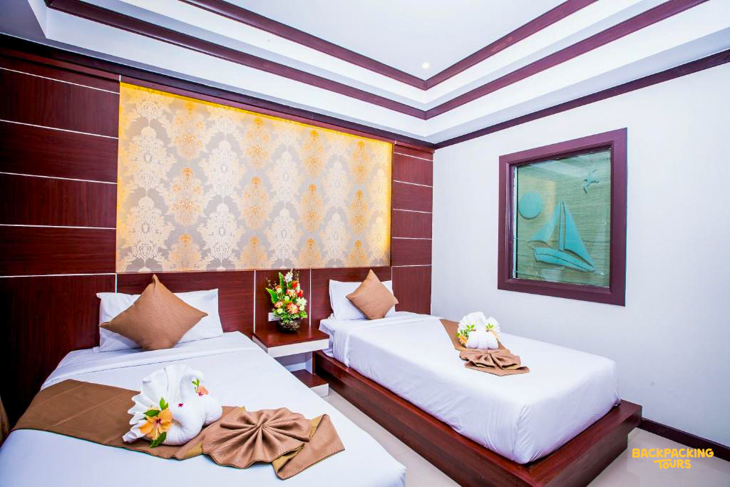 Bright and inviting twin room with two single beds and decorative towel art, typical of Phi Phi Islands.