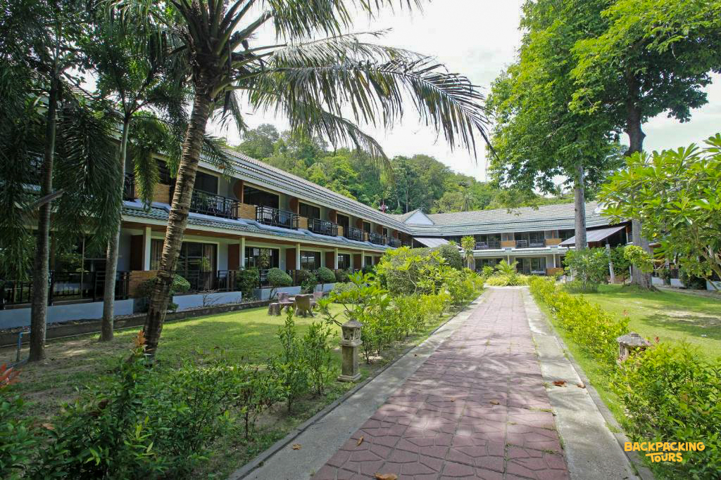 A tropical resort building with balconies and a garden path on Phi Phi Islands.