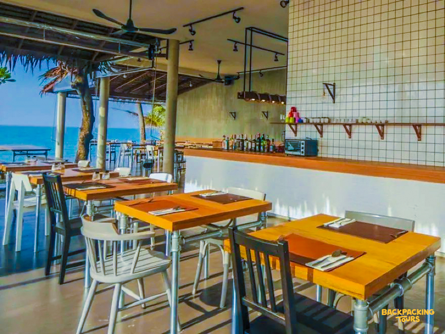 Relax at this open-air restaurant with wooden tables and ocean views in Koh Samui.