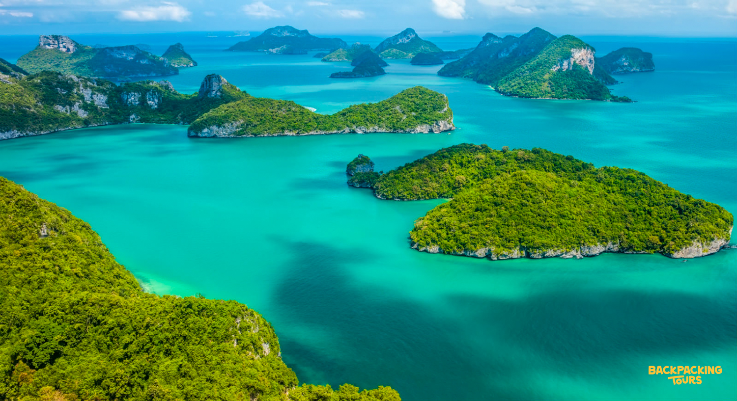 Aerial view of lush green islands scattered across vibrant turquoise waters in Ang Thong National Marine Park.