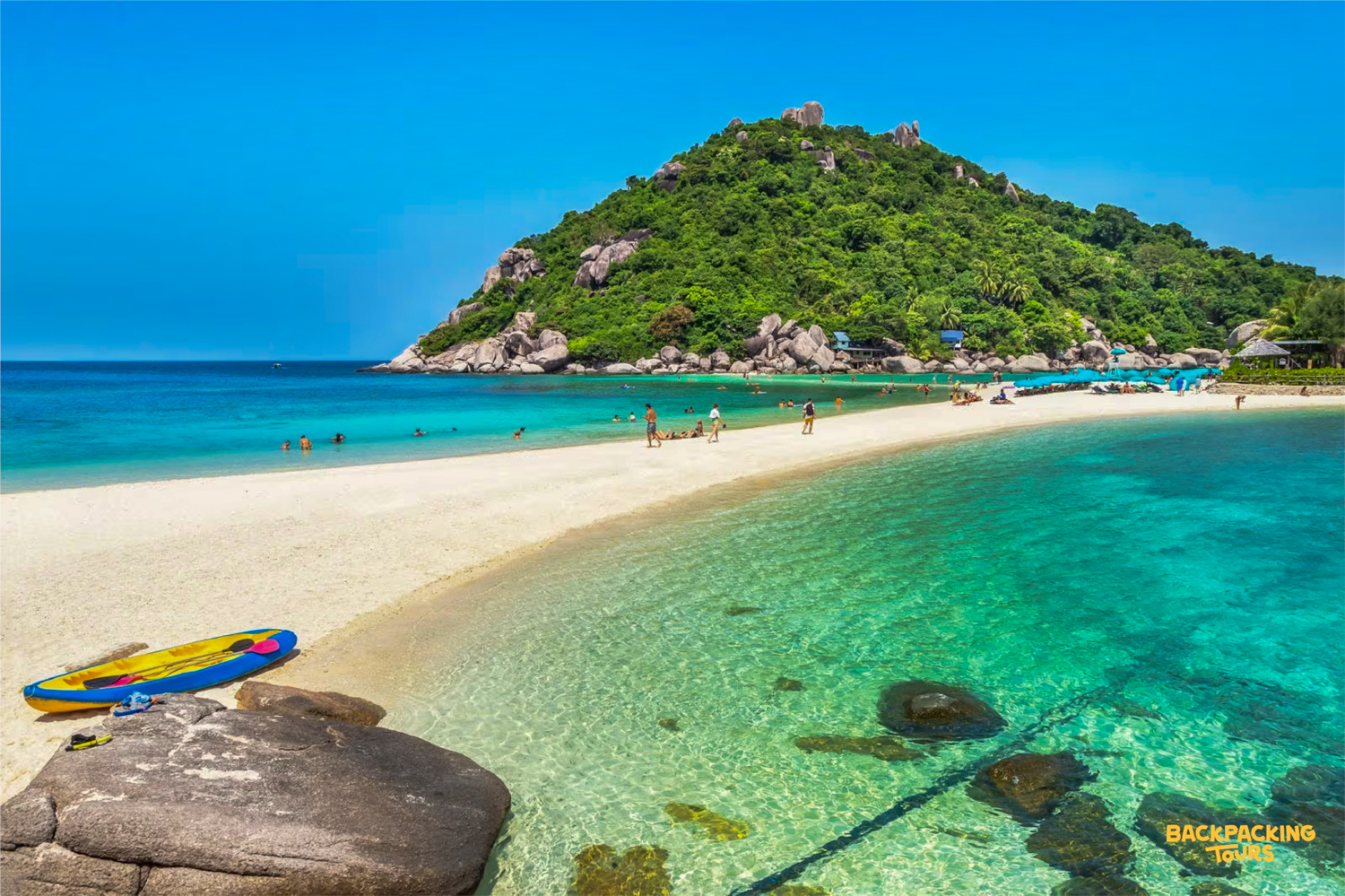 Visitors enjoy the pristine white sandbar and clear turquoise waters of Koh Nang Yuan, Thailand.