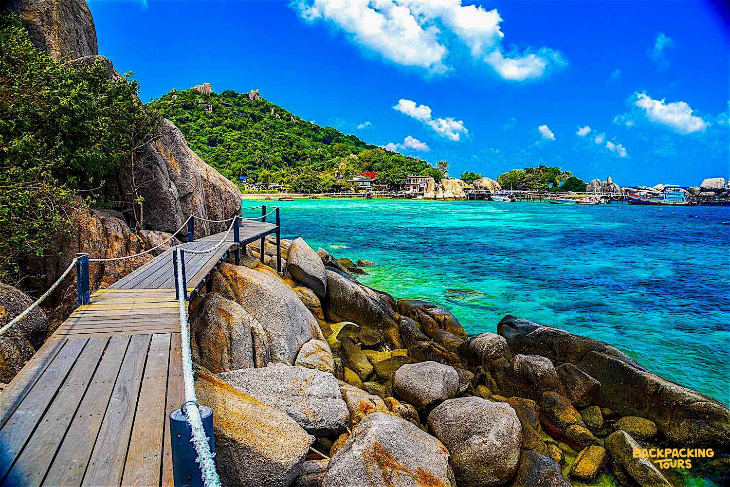 Scenic wooden boardwalk connecting islands at Koh Nang Yuan, with vibrant turquoise ocean.