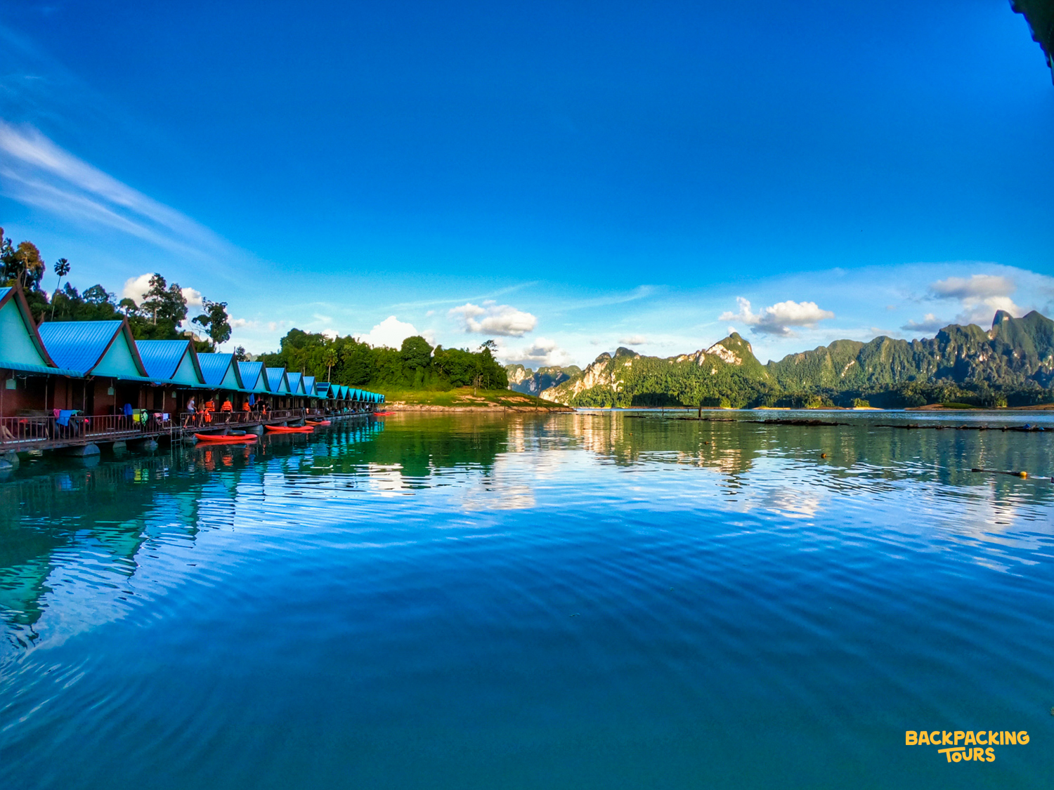Floating bungalows on Cheow Lan Lake, Khao Sok National Park, nestled among towering jungle-clad limestone karsts.