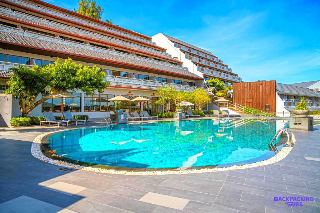 Relaxing by the large outdoor swimming pool at a beautiful resort hotel in sunny Phuket.